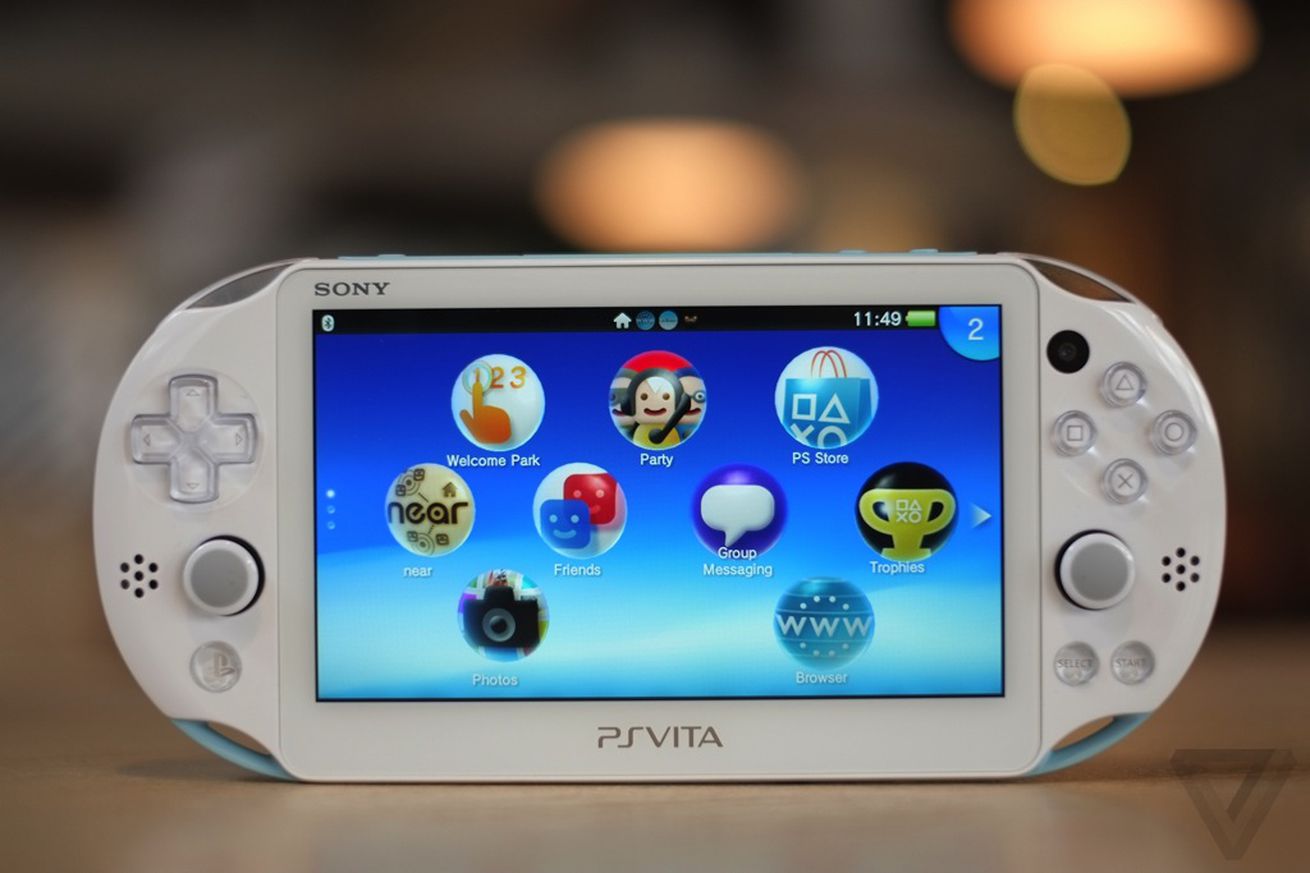 The PS Vita revision facing the camera with its screen on, displaying its bubble-filled user interface.