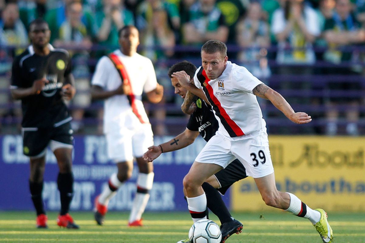 PORTLAND OR - JULY 17:  Craig Bellamy #39 of Manchester City of battles Derek Gaudet #2 the Portland Timbers during a friendly match on July 17 2010 at Merlo Field in Portland Oregon.  (Photo by Jonathan Ferrey/Getty Images)