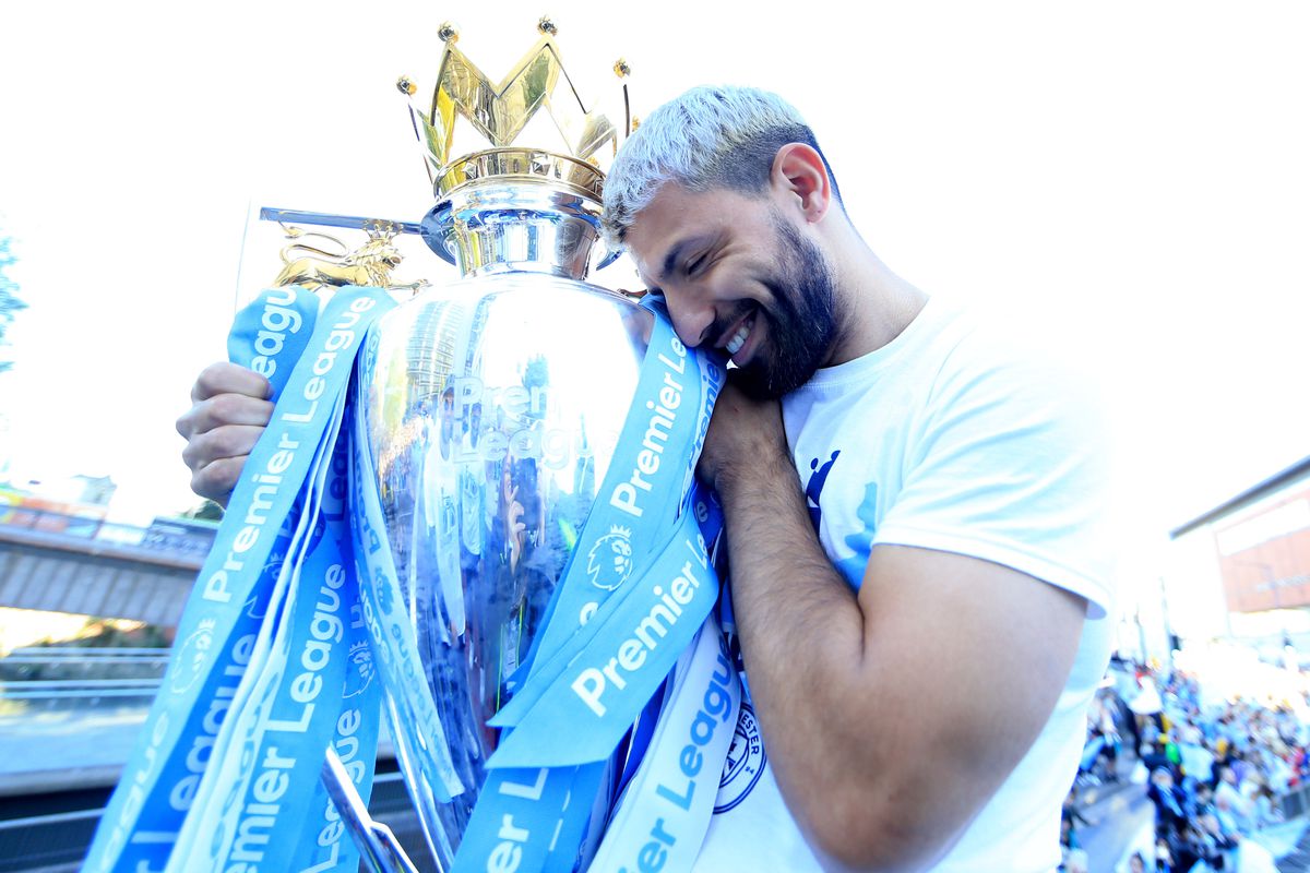 Sergio Aguero cradles league title trophy - Manchester City - Premier League