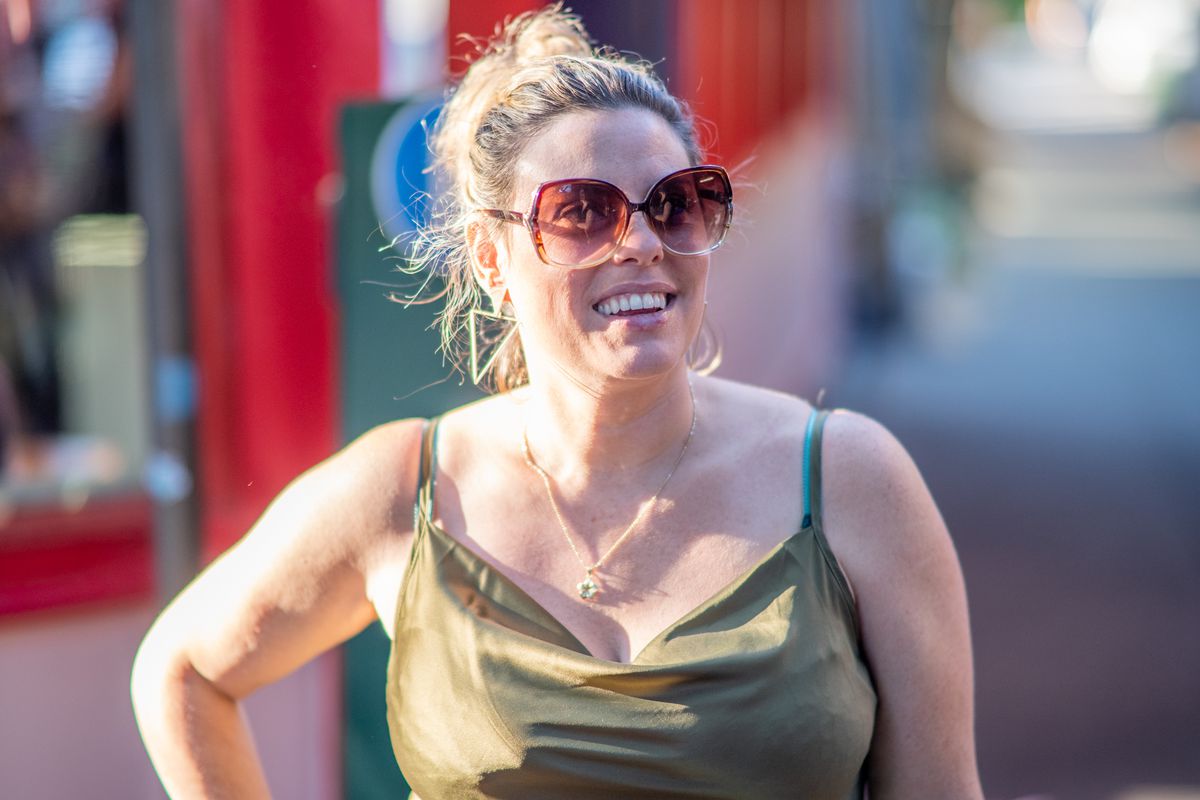 A woman posing wearing sunglasses