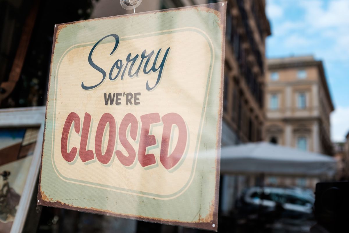A sign that reads “Sorry, We’re Closed” on a door 