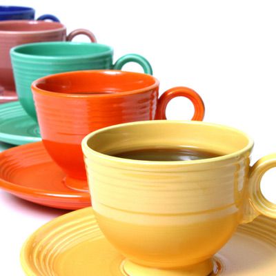 Colorful ceramic mugs lined up in a row.
