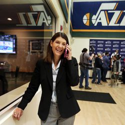 Linda Luchetti makes phone calls at Zions Bank Basketball Center in Salt Lake City, Thursday, Feb. 25, 2016, as players and coaches give interviews in the background.