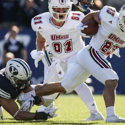 Brigham Young Cougars linebacker Sae Tautu (31) tackles UMass Minutemen wide receiver Andy Isabella (23) during a game at LaVell Edwards Stadium in Provo on Saturday, Nov. 19, 2016.