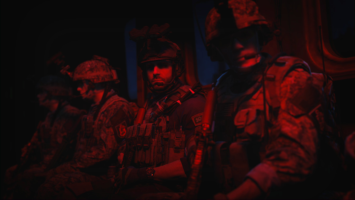 Soldiers from Call of Duty: Modern Warfare 2 (2022) sitting in a helicopter, bathed in red light