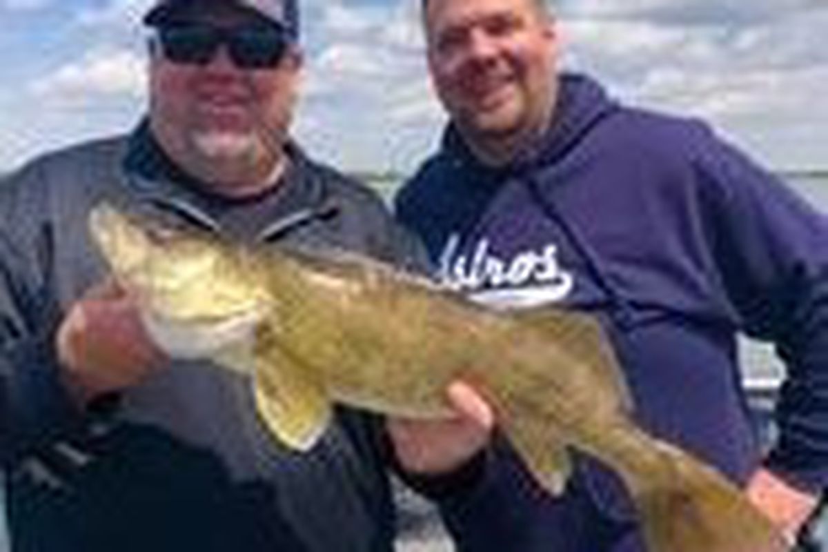 Douglas Wagner (left) holds a big walleye from Heidecke Lake. Provided photo