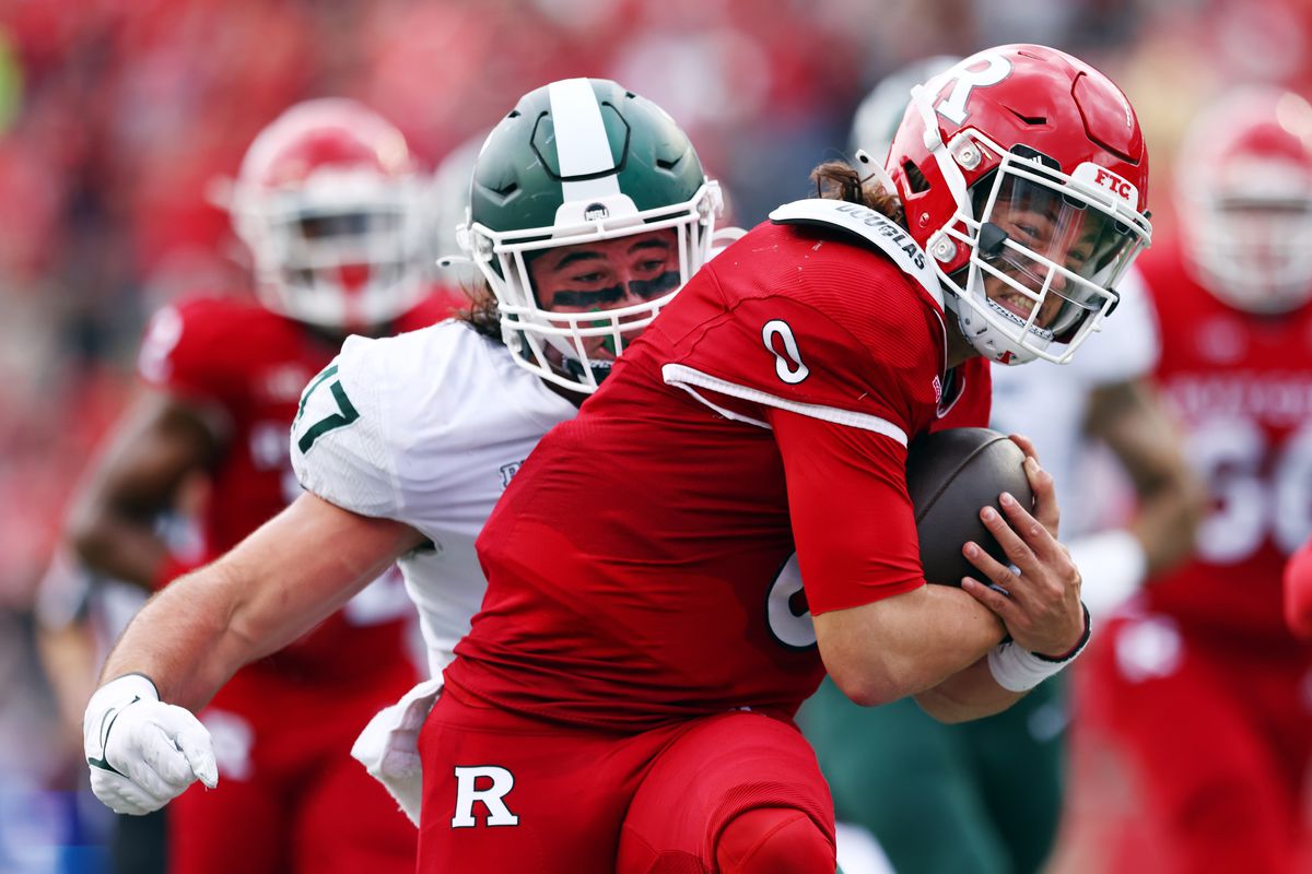 Quarterback Noah Vedral of the Rutgers Scarlet Knights is tackled by Jeff Pietrowski of the Michigan State Spartans after running for a first down during the first quarter of a game at SHI Stadium on October 9, 2021 in Piscataway, New Jersey.