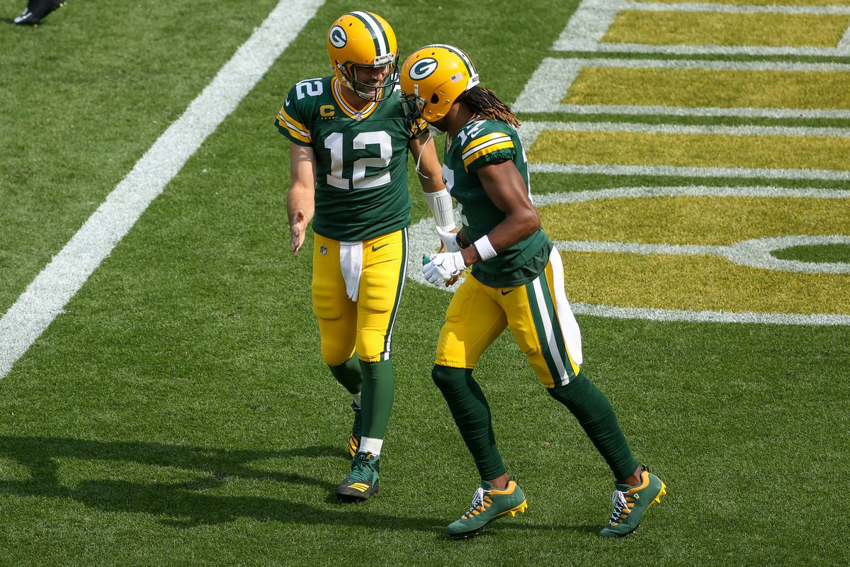 Aaron Rodgers and Davante Adams of the Green Bay Packers celebrate after scoring a touchdown in the third quarter against the Detroit Lions at Lambeau Field on September 20, 2020 in Green Bay, Wisconsin.