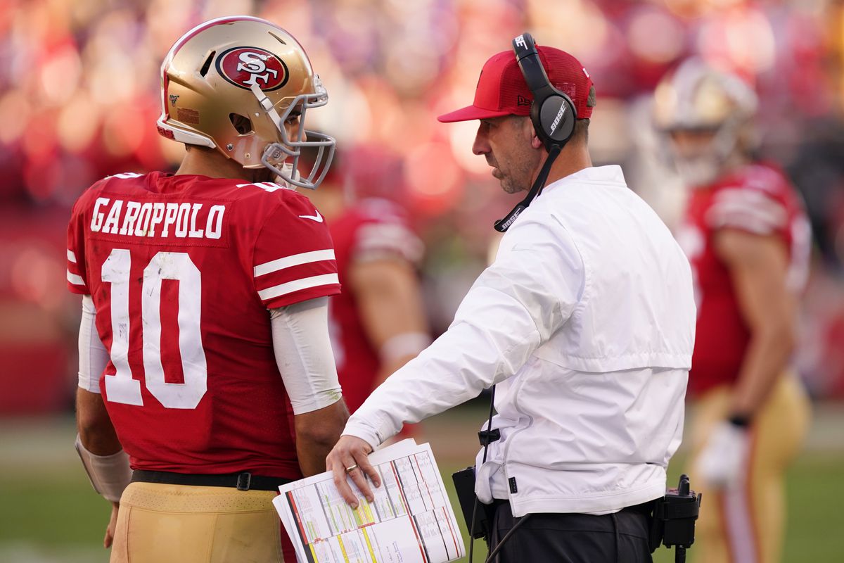 Jimmy Garoppolo #10 speaks with head coach Kyle Shanahan of the San Francisco 49ers during the NFC Divisional Round Playoff game against the Minnesota Vikings at Levi’s Stadium on January 11, 2020 in Santa Clara, California.