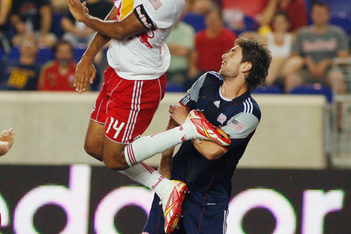 Stephen McCarthy (26) of the New England Revolution defends as Thierry Henry (14) of the New York Red Bulls goes up high to head the ball during the game at Red Bull Arena on June 10, 2011 in Harrison, New Jersey.  (Photo by Andy Marlin/Getty Images)