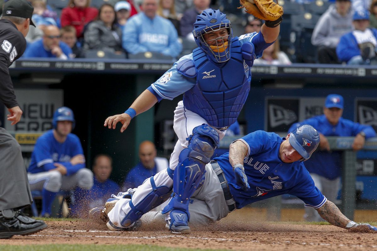 Brett Lawrie of the Toronto Blue Jays slides into home safe past catcher Humberto Quintero of the Kansas City Royals in the 8th after stealing home on a double steal. (Photo by Kyle Rivas/Getty Images)