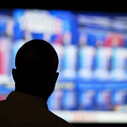 Offei Koram watches a broadcast of a Democratic presidential debate at a bar in Atlanta, Thursday, June 27, 2019.