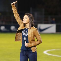 Gina Salvatore waves to the crowd after singing the national anthem on Tuesday night at UConn men’s soccer.