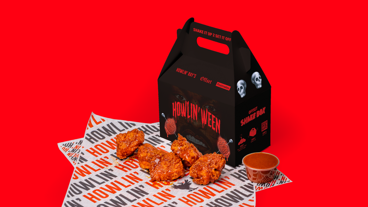 A Howlin’ Ray’s restaurant box next to chicken nuggets with a red background.