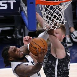 Utah Jazz forward Jae Crowder (99) dunks the ball in front of San Antonio Spurs forward Davis Bertans (42) during a basketball game at the Vivint Smart Home Arena in Salt Lake City on Monday, Feb. 12, 2018.