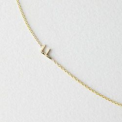 Maya Brenner mini-letter necklace, <a href=".com/VEN_ALL_NA_VA-F_NECKLACE.html?dwvar_VEN__ALL__NA__VA-F__NECKLACE_color=14K%20GOLD#cgid=womens-jewelry-necklaces&frmt=ajax&view=all&start=0&hitcount=57">$220</a> at Steven Alan