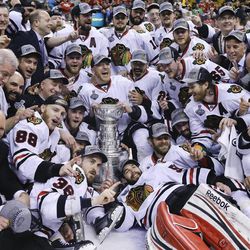 The Chicago Blackhawks pose with the Stanley Cup after the Blackhawks beat the Boston Bruins 3-2 in Game 6 of the NHL hockey Stanley Cup Finals Monday, June 24, 2013, in Boston. (AP Photo/Elise Amendola)