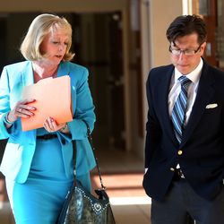 Karmen Sanone arrives at 3rd District Court with her attorney, Aaron Bergman, for a hearing in the guardianship case for Salt Lake County Recorder Gary Ott in West Jordan on Friday, July 14, 2017. Sanone is an office aide in the recorder's office and calls herself Ott's "longtime friend."