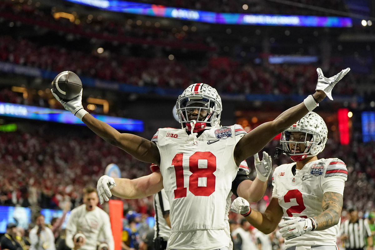 Ohio State Buckeyes wide receiver Marvin Harrison Jr. reacts after scoring a touchdown against the Georgia Bulldogs during the second quarter of the 2022 Peach Bowl at Mercedes-Benz Stadium.