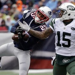New England Patriots defensive back Eric Rowe (25) intercepts a pass intended for New York Jets wide receiver Brandon Marshall (15) during the first half of an NFL football game, Saturday, Dec. 24, 2016, in Foxborough, Mass. (AP Photo/Elise Amendola)
