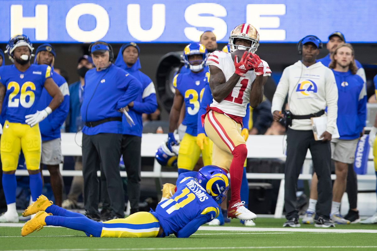 Brandon Aiyuk #11 of the San Francisco 49ers runs after making a catch during the game against the Los Angeles Rams at SoFi Stadium on January 30, 2022 in Inglewood, California. The Rams defeated the 49ers 20-17.