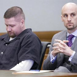 Timmy Olsen looks down at his hands as he and his Attorney Jeremy M. Delicino (CQ) listen to Richard Davis speak in the State of Utah Third Judicial District Court Thursday, Feb. 10, 2011.  Olsen plead guilty to manslaughter in Kiplyn Davis's death. (Scott G Winterton, Deseret News)