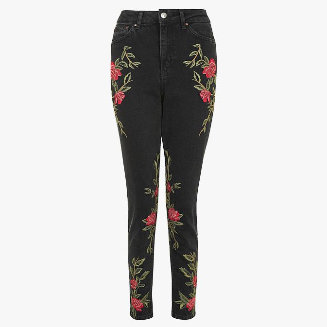 black jeans embroidered with red roses