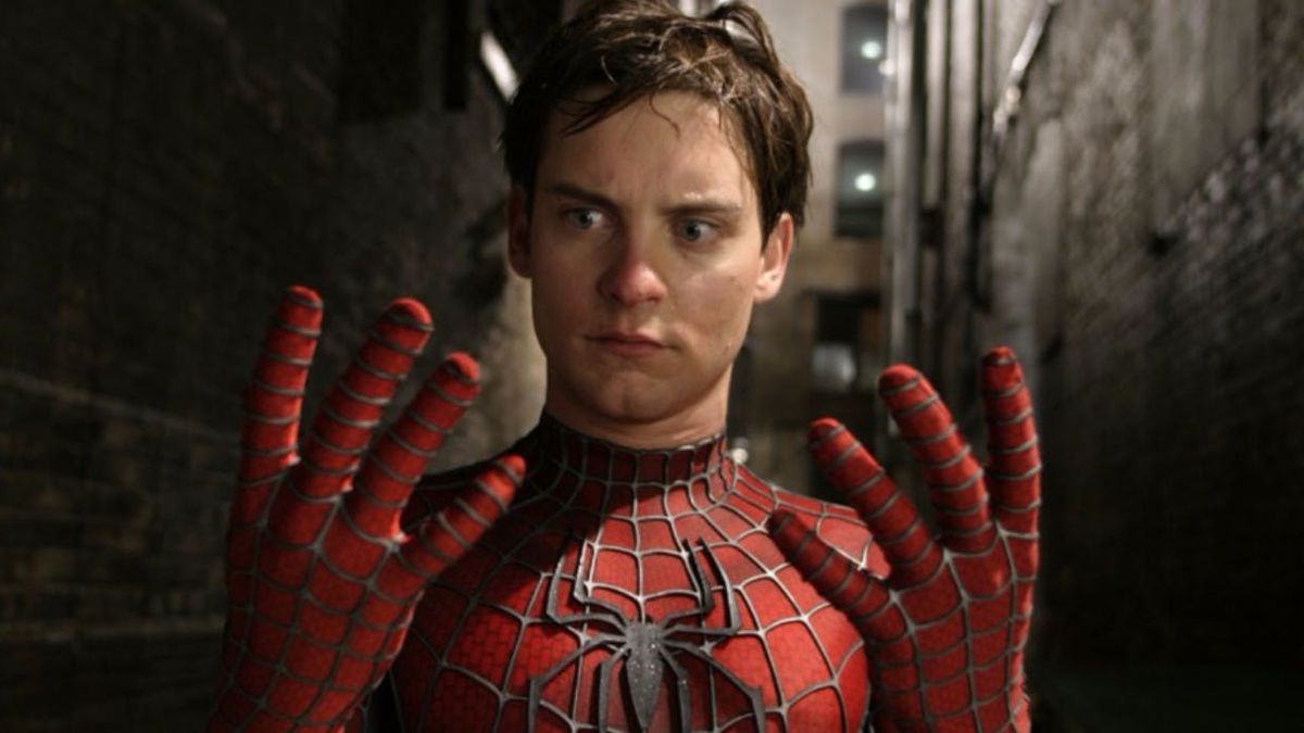 Tobey Maguire as Spider-Man looking at his hands with his mask off