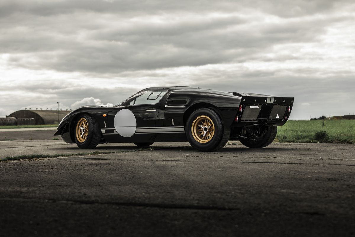 Black Ford GT40 in profile-rear view on a concrete track
