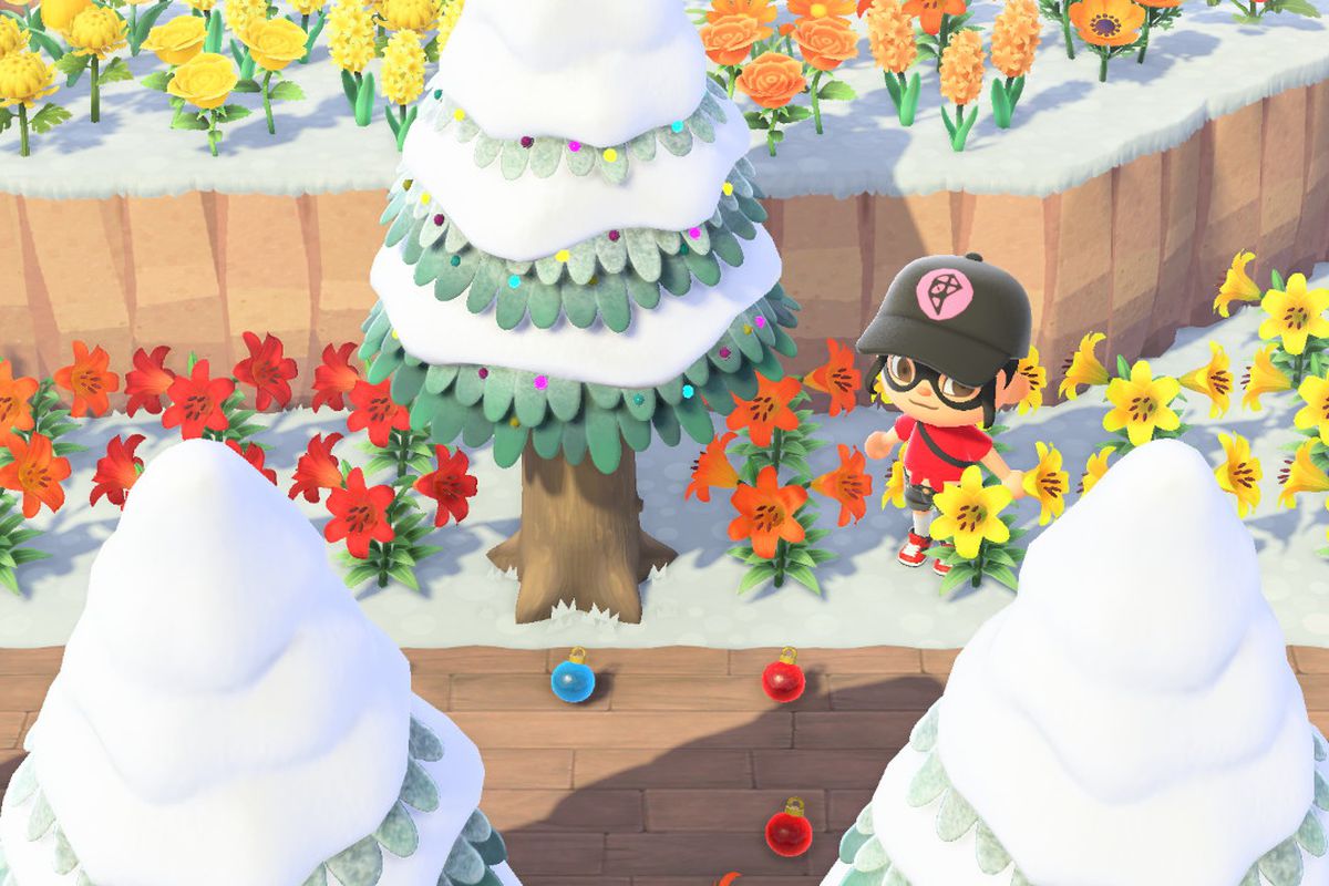 Colorful ornaments scatter the floor under a pine tree in Animal Crossing: New Horizons