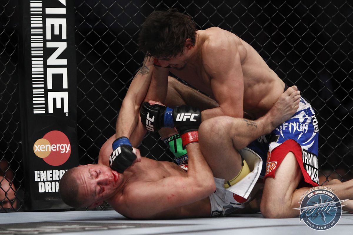 Pablo Garza (top) drops a big fight hand on Mark Hominick (bottom) in the opening bout of the UFC 154 main card last night