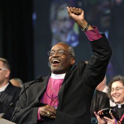 Bishop Michael Curry, of North Carolina, waves to the crowd after being elected the Episcopal Church's first African-American presiding bishop at the Episcopal General Convention Saturday, June 27, 2015, in Salt Lake City. Curry won the voting in a landslide. 