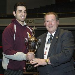 In this Feb. 17, 2010, photo, Tamerlan Tsarnaev, left, accepts the trophy for winning the 2010 New England Golden Gloves Championship from Dr. Joseph Downes, right, in Lowell, Mass. Tsarnaev, 26, who had been known to the FBI as Suspect No. 1 in the Boston Marathon Explosions and was seen in surveillance footage in a black baseball cap, was killed overnight on Friday, April 19, 2013, officials said.