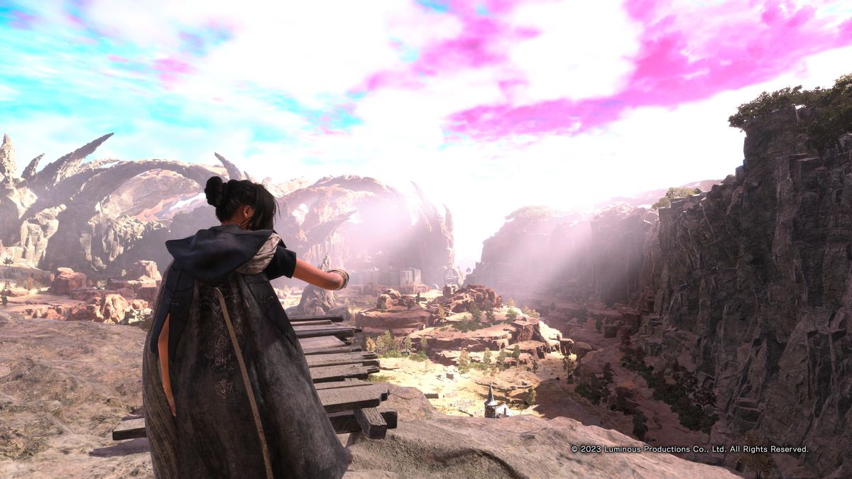 Frey looks out over a cliff-studded, borderline desert area of Athia in Forspoken