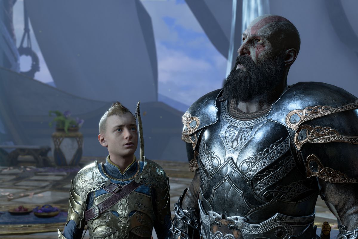 Atreus looking up at Kratos, who is looking upward off screen, in God of War Ragnarök, with both characters wearing shiny armor