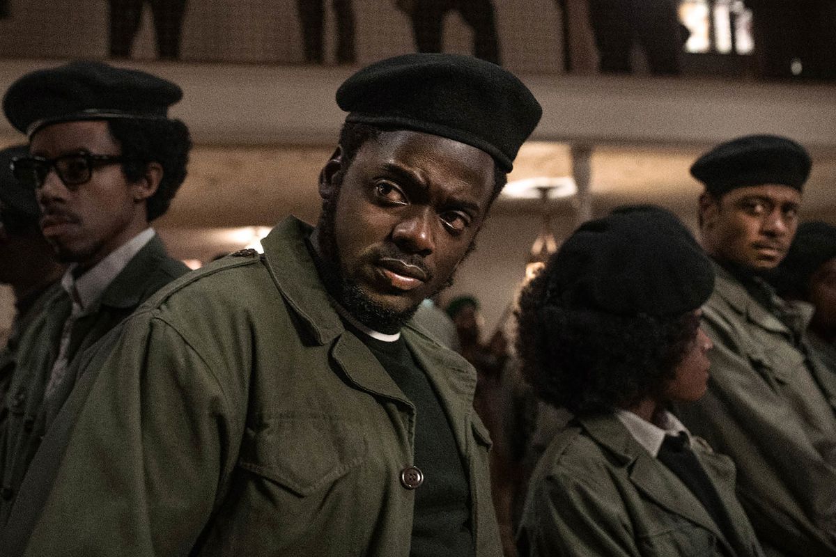 In an image from the film Judas and the Black Messiah, young Black Panthers stand wearing green jackets and black berets.