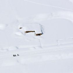 A house is covered with snow from an avalanche in the Paryan district of Panjshir province, north of Kabul, Afghanistan, Friday, Feb. 27, 2015. The death toll from severe weather that caused avalanches and flooding across much of Afghanistan has jumped to more than 200 people, and the number is expected to climb with cold weather and difficult conditions hampering rescue efforts, relief workers and U.N. officials said Friday. 