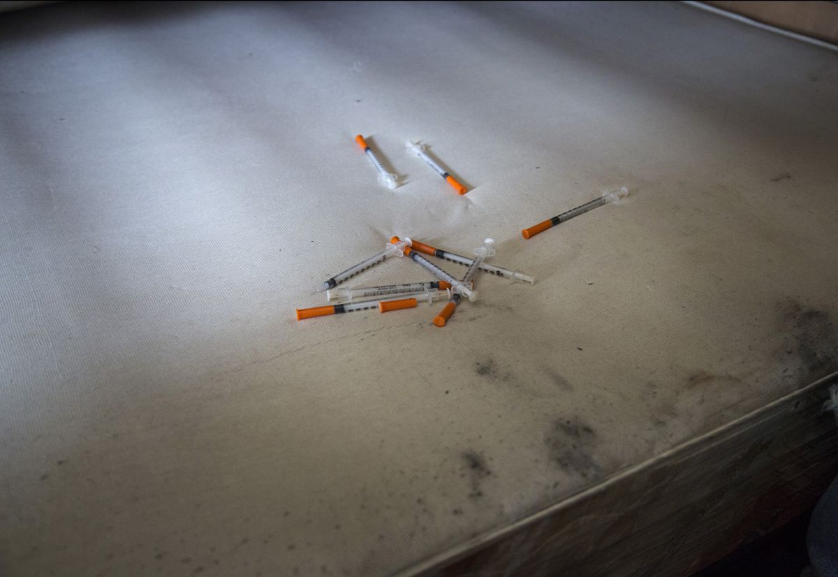 Syringes on a dirty mattress.