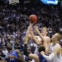 Brigham Young Cougars forward Kyle Davis (21) pushes up a shot over Creighton Bluejays forward Zach Hanson (40) as BYU and Creighton play in NIT quarterfinal action at the Marriott Center in Provo Tuesday, March 22, 2016.