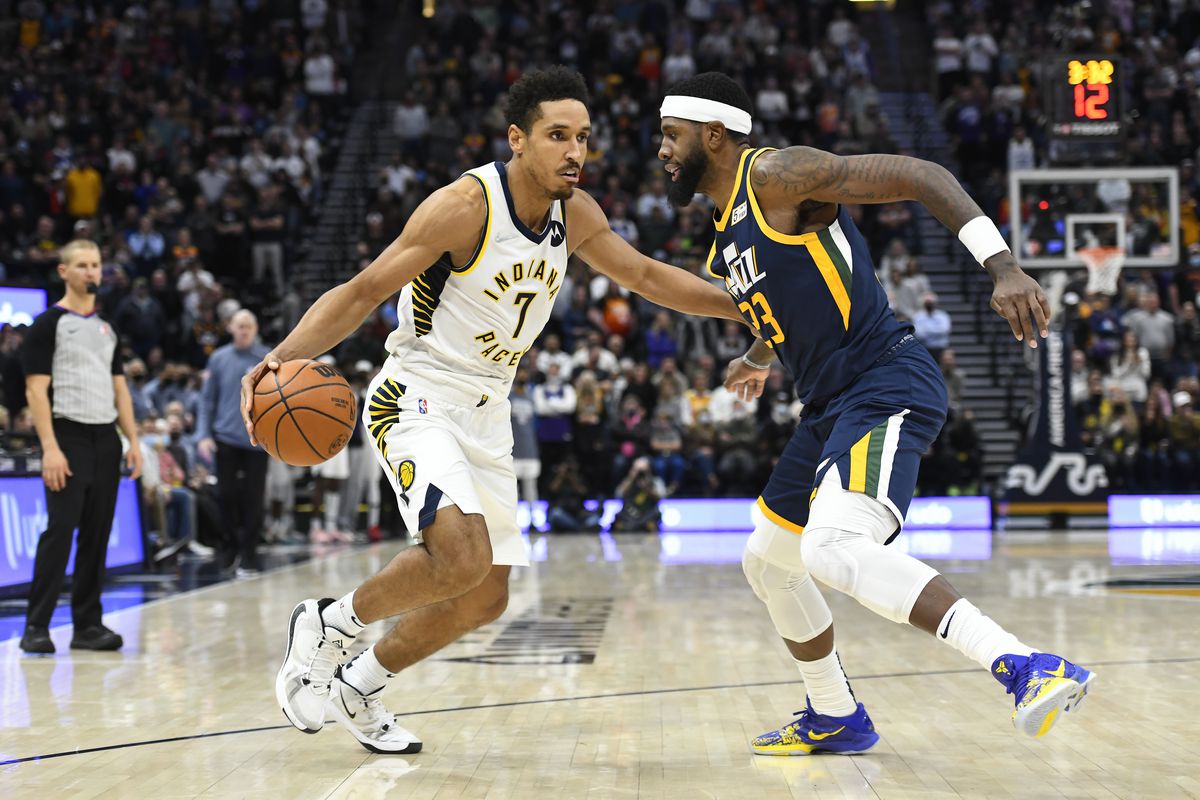 Malcolm Brogdon #7 of the Indiana Pacers drives into Royce O’Neale #23 of the Utah Jazz during a game at Vivint Smart Home Arena on November 11, 2021 in Salt Lake City, Utah.