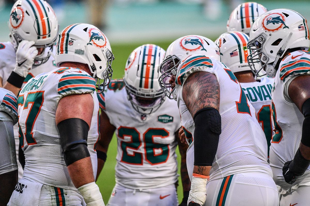 Miami Dolphins offense huddles during the game against the Los Angeles Chargers at Hard Rock Stadium on November 15, 2020 in Miami Gardens, Florida.  