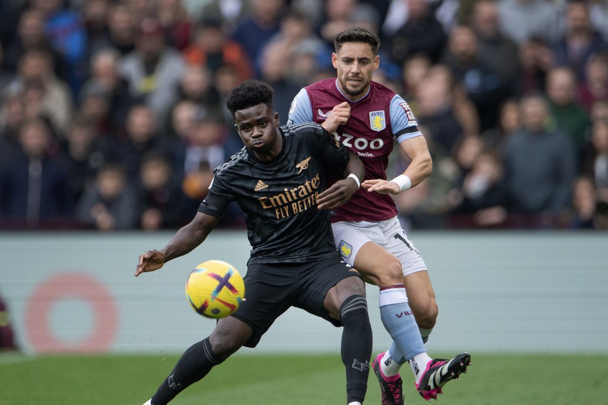 Bukayo Saka of Arsenal and Alex Moreno of Aston Villa in action during the Premier League match between Aston Villa and Arsenal FC at Villa Park on February 18, 2023 in Birmingham, United Kingdom.