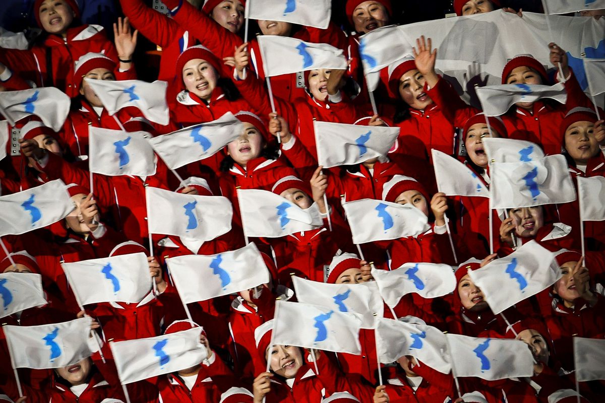 North Korean cheerleaders wave "unification flags" ahead of the opening ceremony.