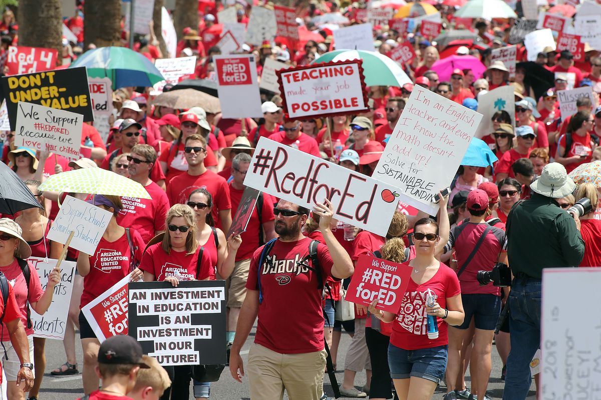 Striking Arizona teachers march toward the State Capitol, in Phoenix, as part of a rally for the #REDforED movement, in April.