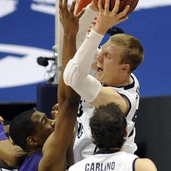 BYU forward Eric Mika (00) grabs a rebound and is fouled by Prairie View A&M Panthers center Reggis Onwukamuche (35) during a game at the Marriott Center in Provo on Wednesday, Dec. 11, 2013.