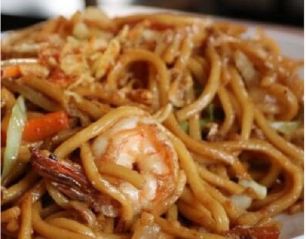 A tangle of dark noodles with a shrimp visible.