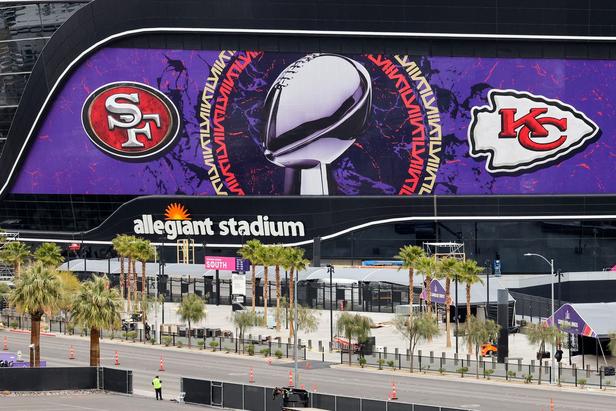 An exterior view shows an image of the Lombardi Trophy, team logos and signage for Super Bowl LVIII at Allegiant Stadium on February 01, 2024 in Las Vegas, Nevada.
