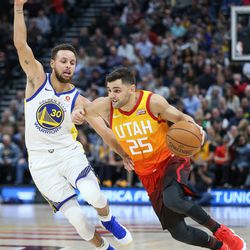Utah Jazz guard Raul Neto (25) drives against Golden State Warriors guard Stephen Curry (30) at Vivint Arena in Salt Lake City on Tuesday, Jan. 30, 2018.