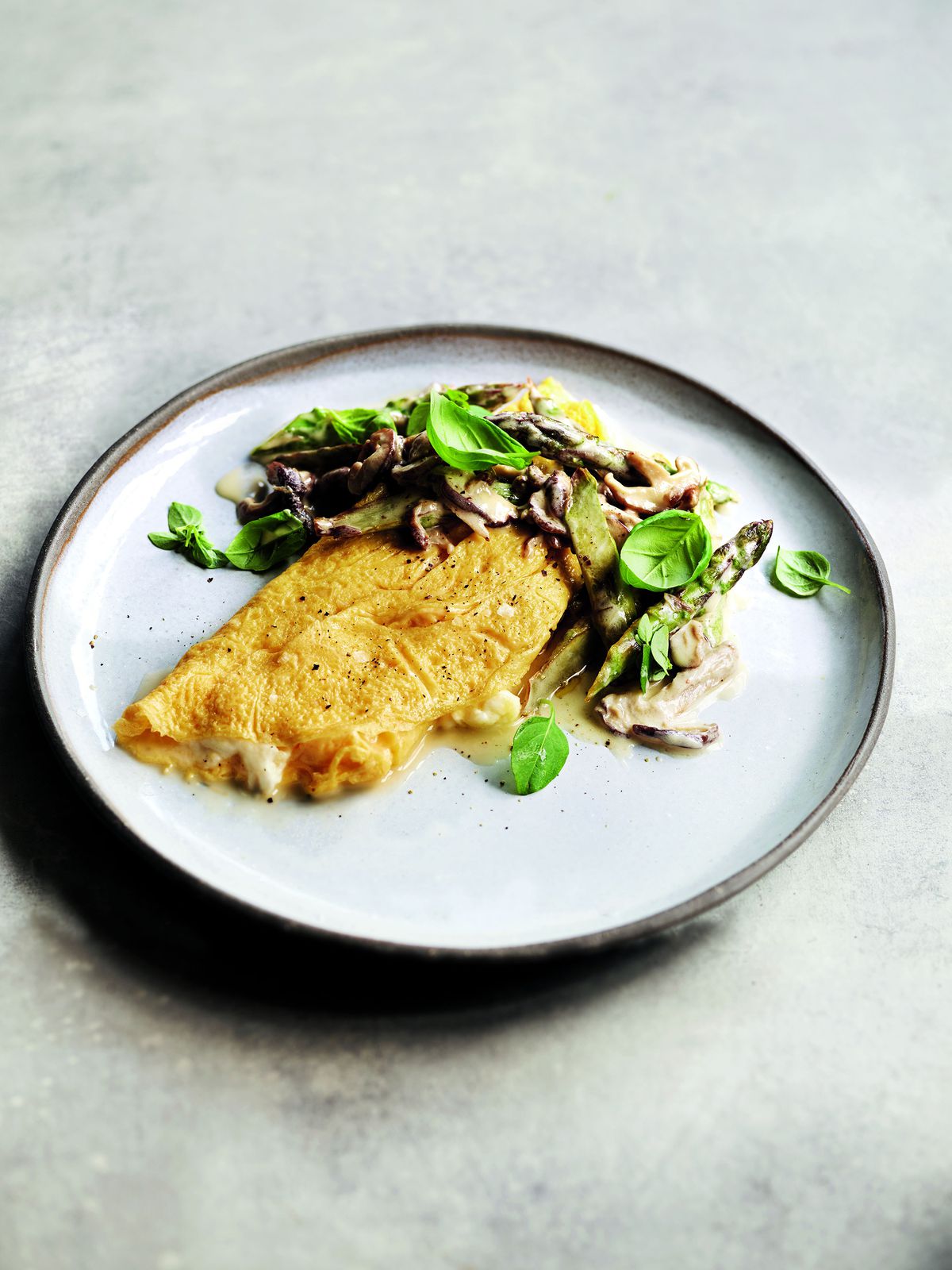 This image posted by Hachette Book Group shows a recipe for mozzarella and basil omelette with asparagus and shiitake mushrooms from Gordon Ramsay's new book 
