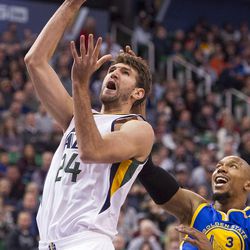Utah center Jeff Withey (24) shoots the ball as Golden State forward David West (3) pressures during the first half of an NBA basketball game in Salt Lake City on Thursday, Dec. 8, 2016.